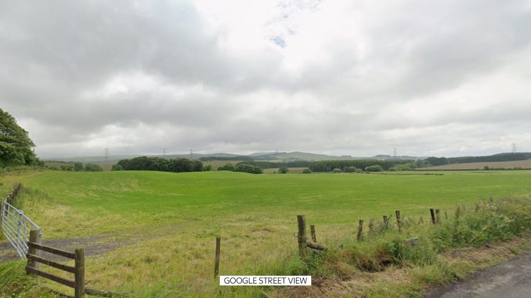 Three men arrested after body found in field