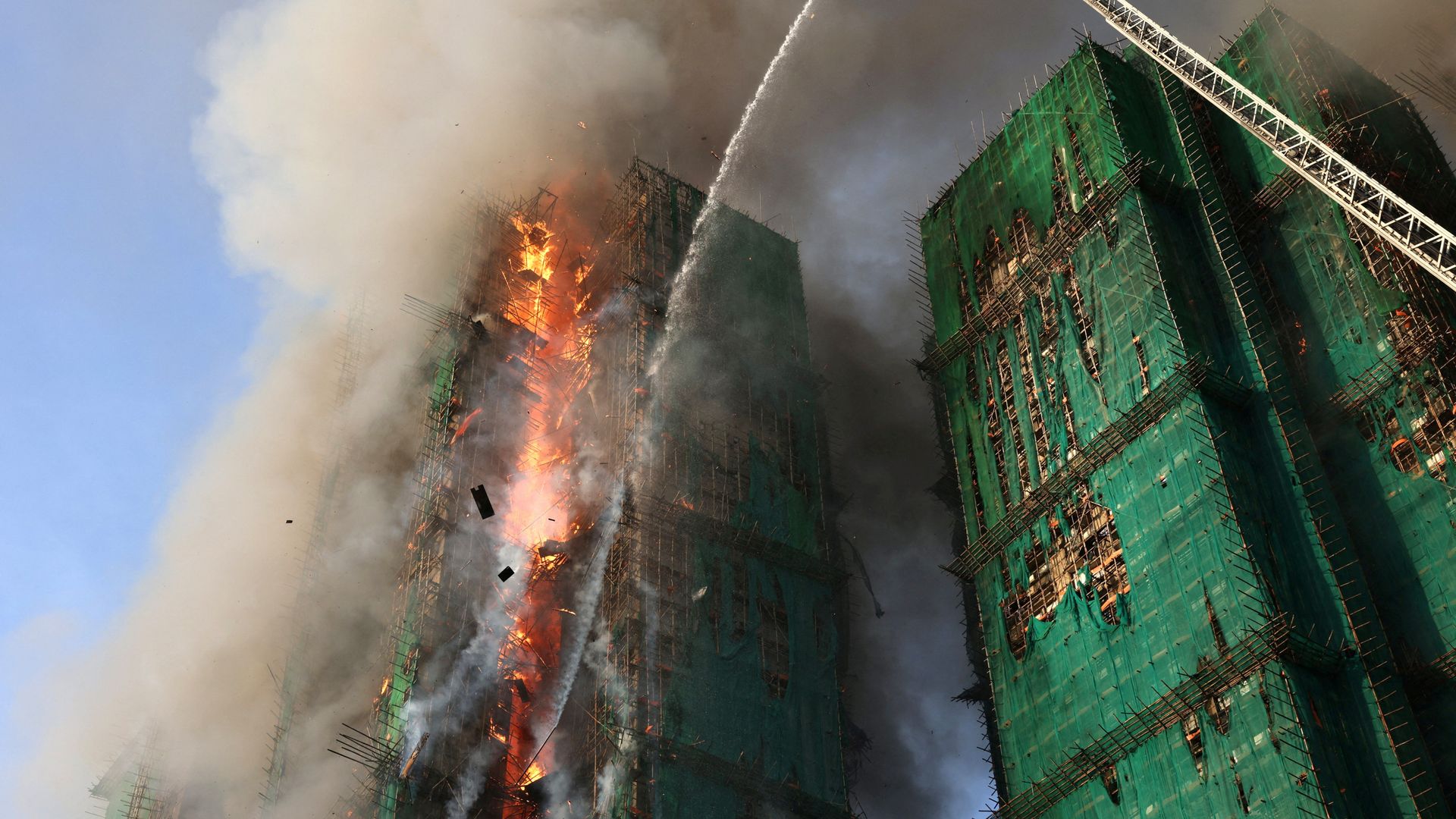 Unknown number of people trapped as huge fire engulfs high-rise buildings in Hong Kong