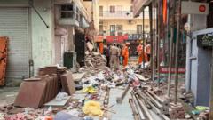 Rescuers dig through debris as seven dead in building collapse in Delhi